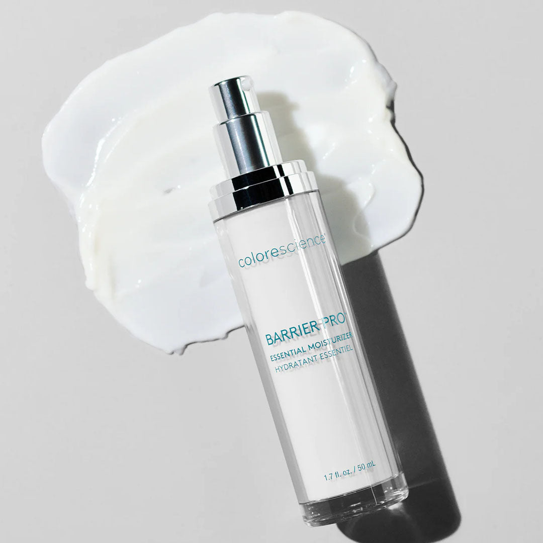Colorescience Barrier Pro Essential Moisturizer pump bottle on a white background with a smear of white cream.