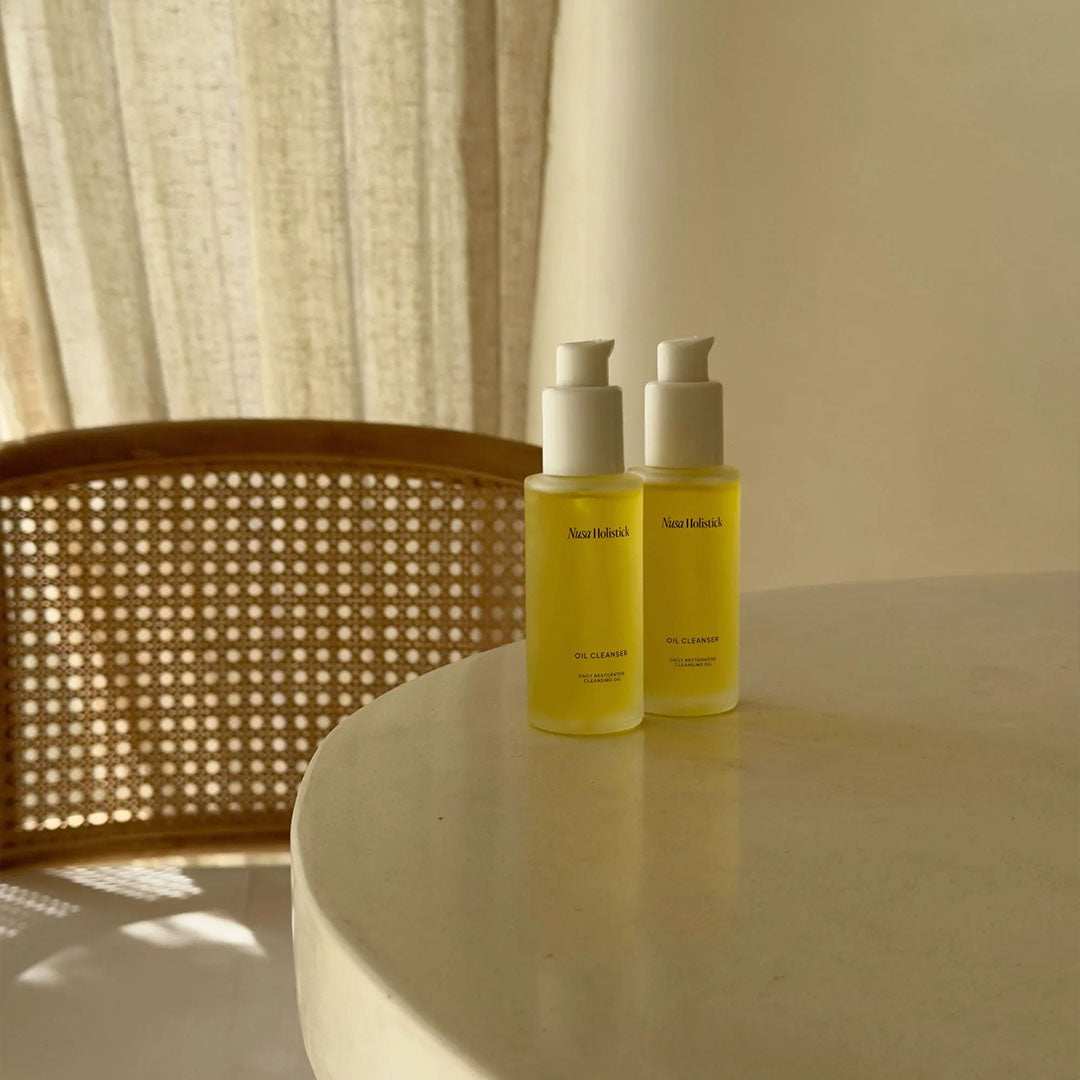 Bottle of Daily Restorative Cleansing Oil used for gentle skincare cleansing and exfoliation