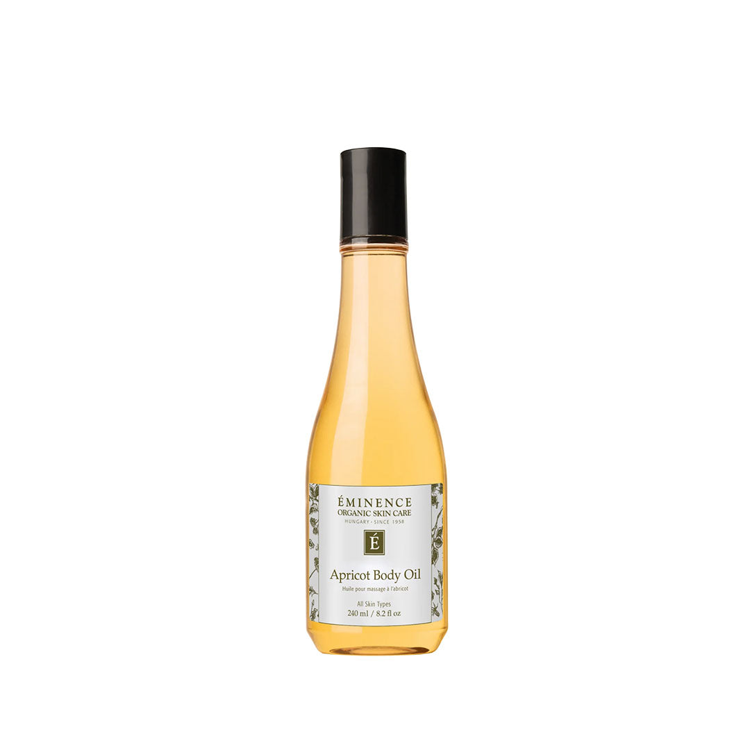 8.2 oz bottle of Eminence Apricot Body Oil with a black cap and golden liquid in a clear glass bottle.