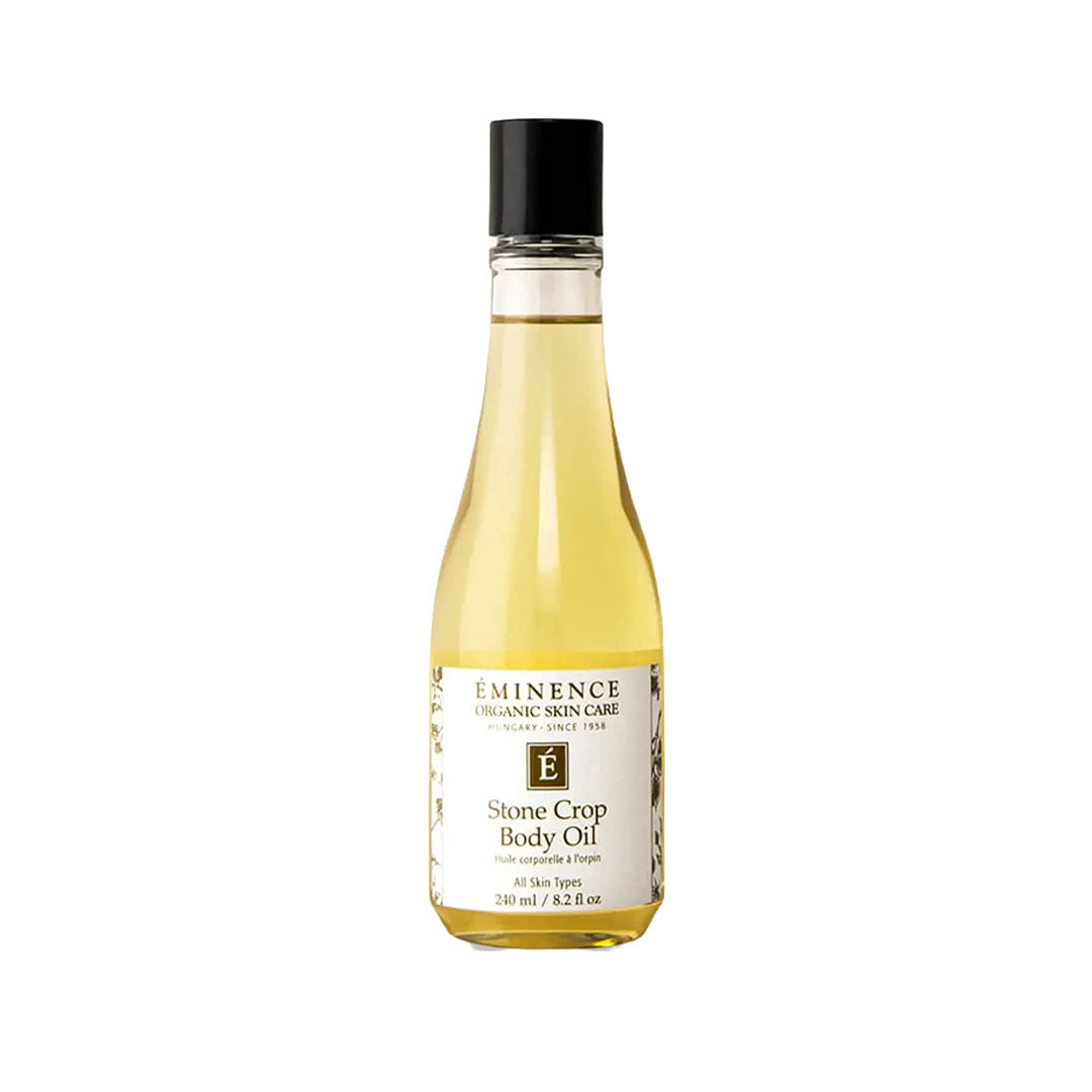 Eminence Stone Crop Body Oil in a clear 240ml glass bottle with a black cap and white label against a white background.