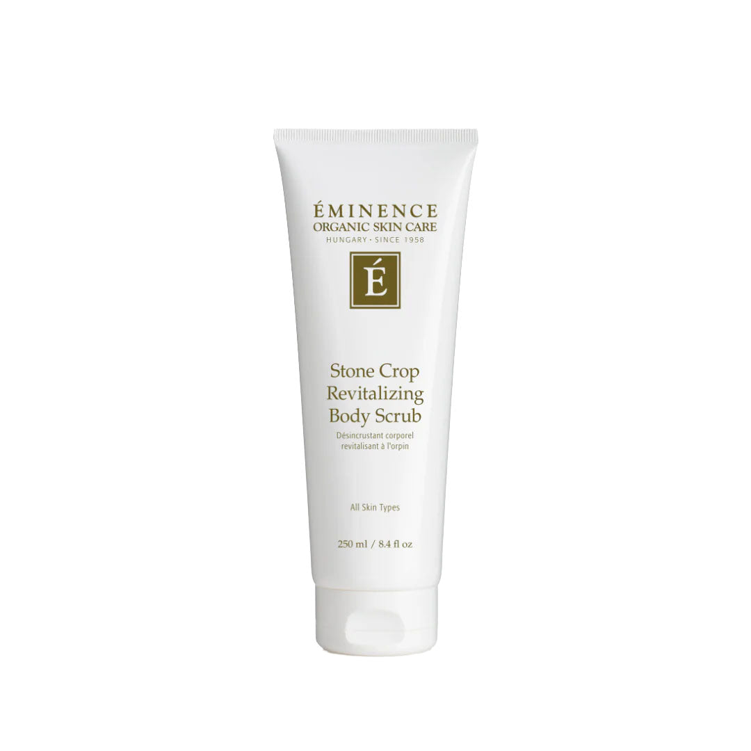 White 8.4 oz squeeze tube of Eminence Stone Crop Revitalizing Body Scrub with green logo and text on a white background.