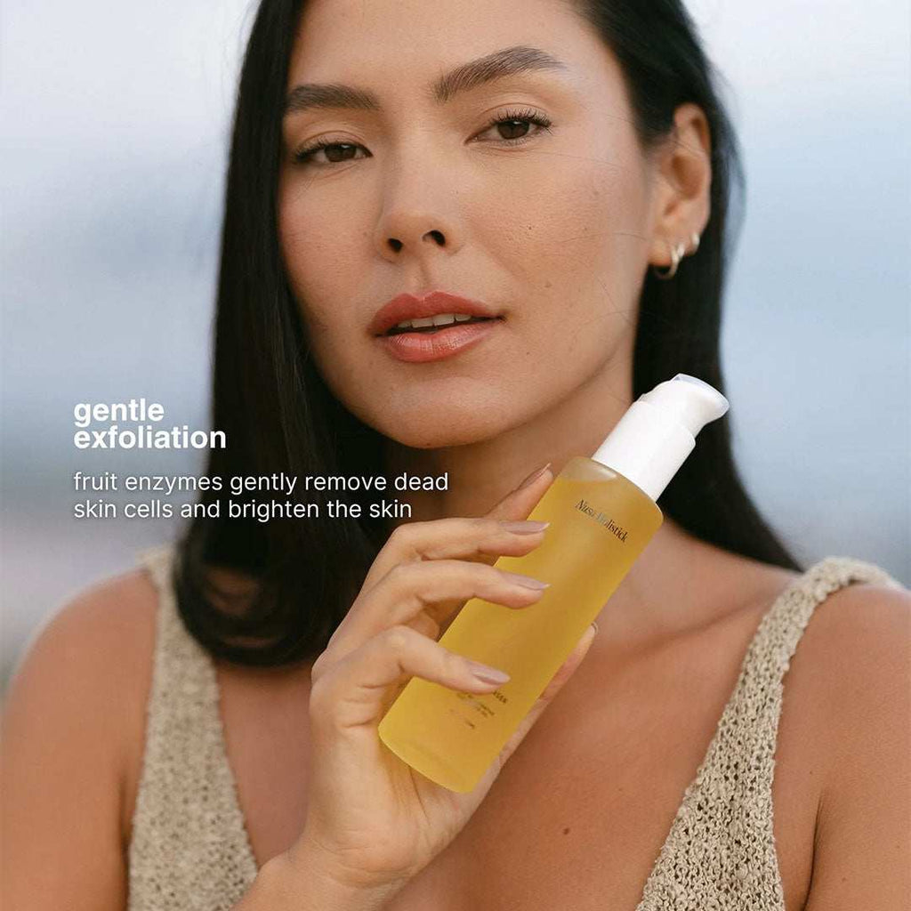 Daily Restorative Cleansing Oil bottle with natural fruit ingredients for gentle exfoliation and deep cleansing