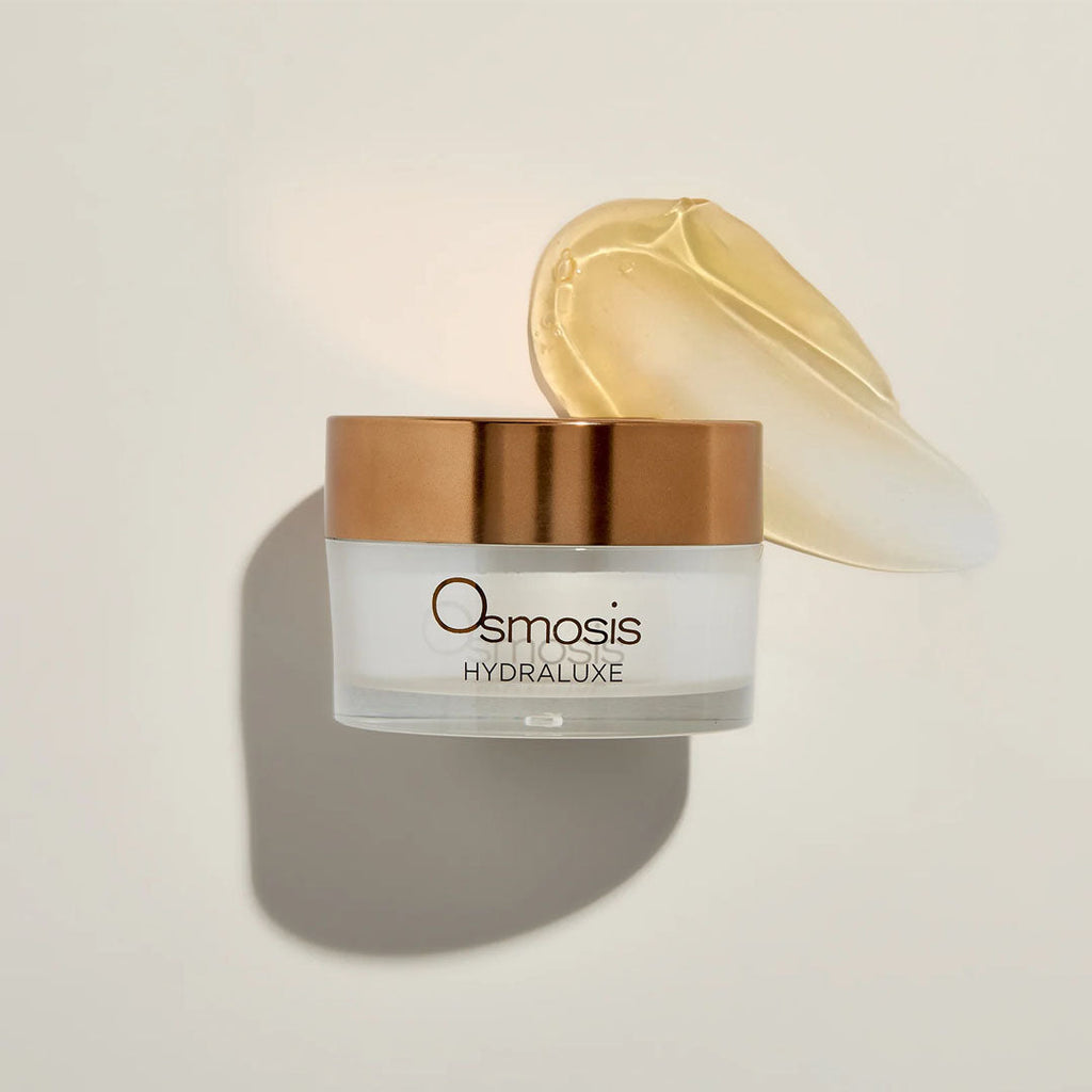 Osmosis Hydraluxe Mask in a white jar with a copper lid, next to a golden gel swatch.