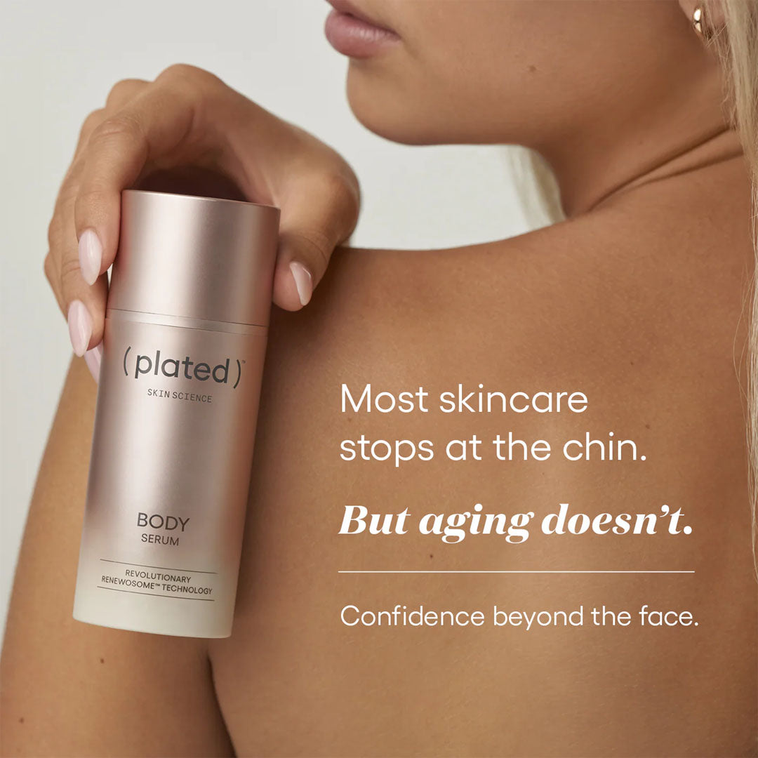 A woman holds a frosted glass bottle of (plated) Body Serum, with her shoulder and lower face visible against a clean light background. White text on the right reads, 'Most skincare stops at the chin.