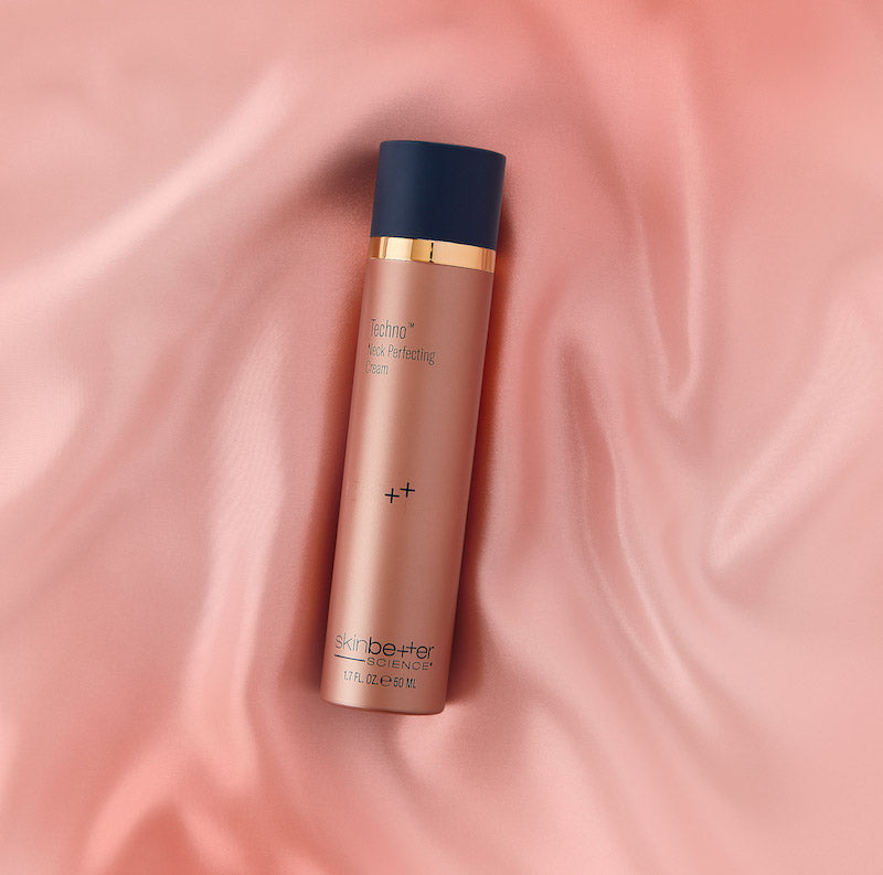 skinbetter techno neck perfecting cream pink silk background