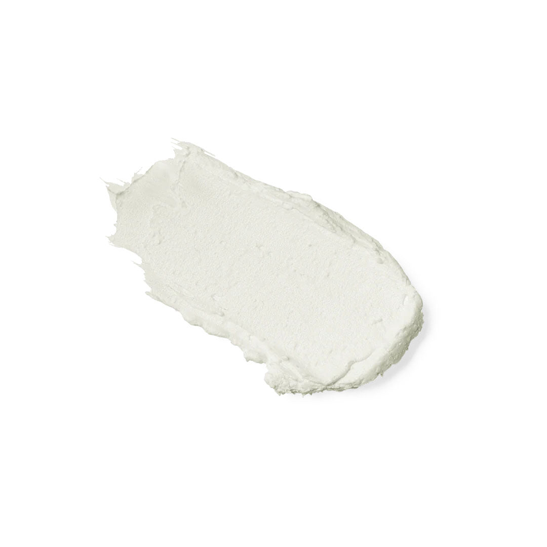 Creamy white smear of Sunforgettable mineral sunscreen stick on a white background.