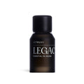 Small, dark brown Vitruvi Legacy essential oil blend bottle with a black cap on a white background.