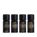 Four dark amber glass Vitruvi essential oil blend bottles with black caps, labeled Legacy, Sleep, Pacific, and Gold.